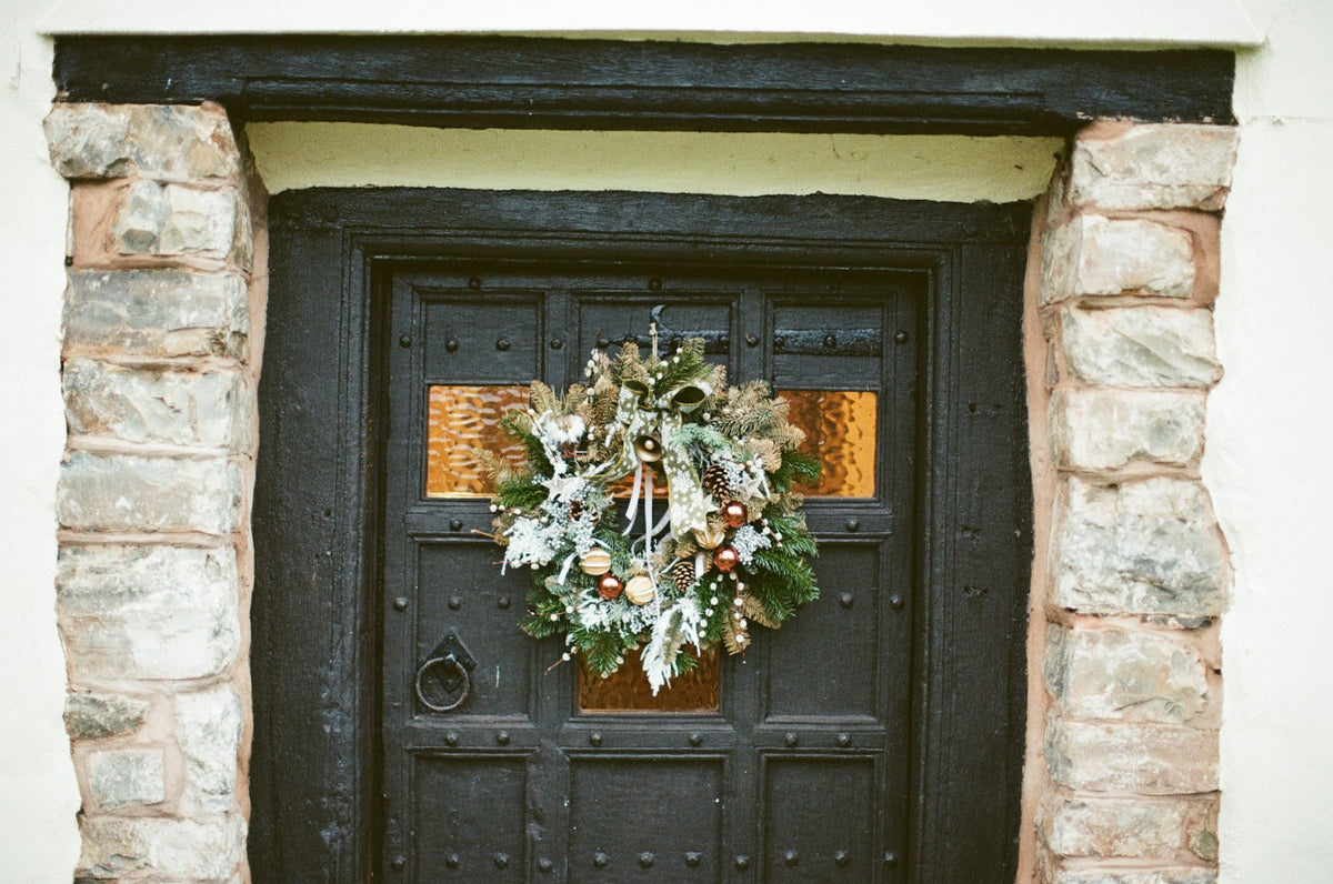 Front door with a festive Christmas wreath